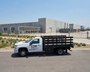 Firefly_Gemini Flash_Place this delivery van at a modern data center campus- long low server buildings wit 772194